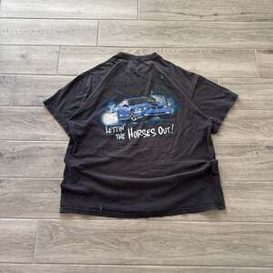 Vintage Sun Faded Ford Mustang Let The Horses Out Graphic Tee.